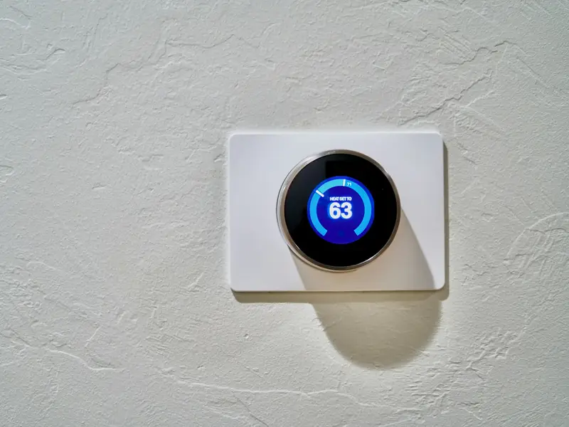 Smart thermostat on a white wall
